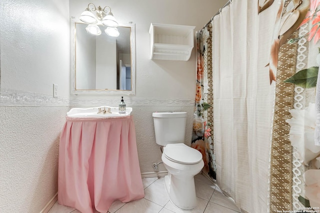 full bathroom with wainscoting, vanity, toilet, and tile patterned floors