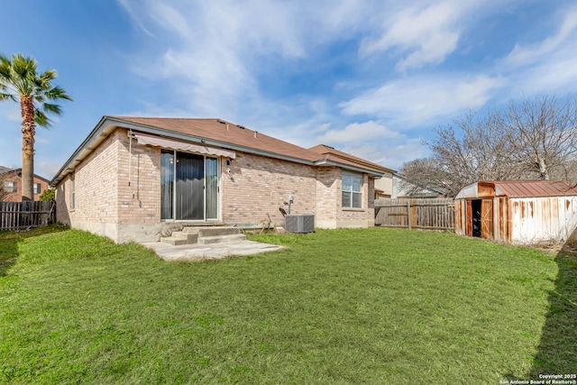 back of property featuring entry steps, cooling unit, brick siding, and a lawn