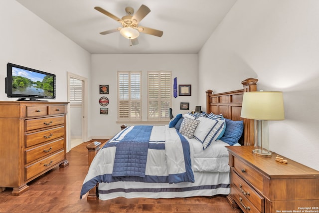 bedroom featuring dark wood-type flooring, ceiling fan, and baseboards