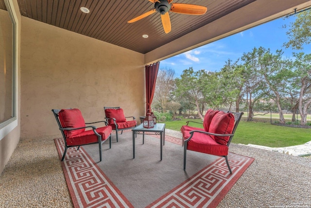 view of patio featuring outdoor lounge area, fence, and a ceiling fan