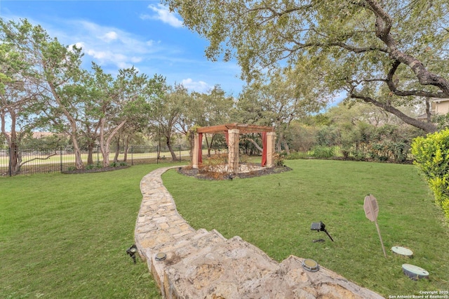 view of yard featuring fence and a pergola