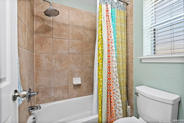 full bathroom featuring toilet and shower / bathtub combination with curtain