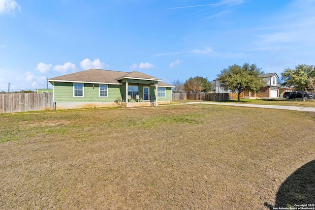 ranch-style house with a front yard and fence