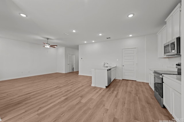 1522 Silver Run, New Braunfels, TX 78130 - kitchen with stainless steel appliances, recessed lighting, open floor plan, white cabinets, and ceiling fan