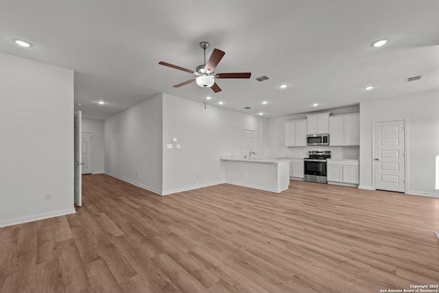 1522 Silver Run, New Braunfels, TX 78130 - unfurnished living room with ceiling fan, baseboards, light wood finished floors, and recessed lighting