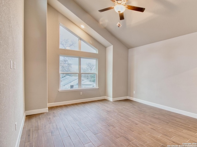 additional living space featuring ceiling fan, vaulted ceiling, baseboards, and wood finished floors