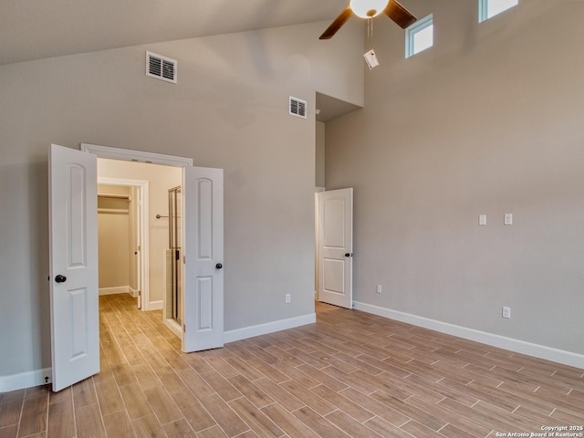 unfurnished bedroom featuring light wood-style floors, baseboards, and visible vents