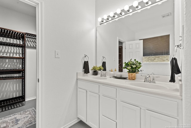 bathroom with tile patterned flooring, visible vents, a sink, and double vanity