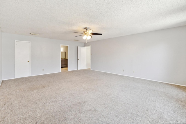 unfurnished room featuring light carpet, ceiling fan, and a textured ceiling