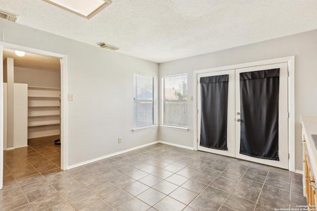 unfurnished bedroom featuring a closet, tile patterned flooring, and visible vents