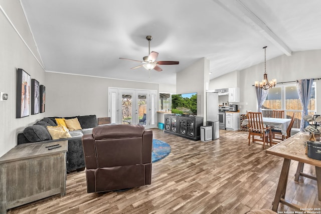 living area with lofted ceiling with beams, french doors, wood finished floors, and ceiling fan with notable chandelier