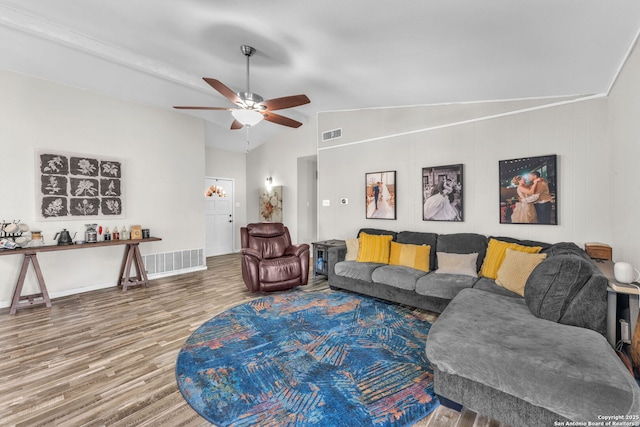 living area featuring vaulted ceiling, ceiling fan, wood finished floors, and visible vents