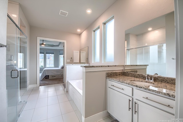 ensuite bathroom with a stall shower, tile patterned flooring, vanity, and ensuite bathroom