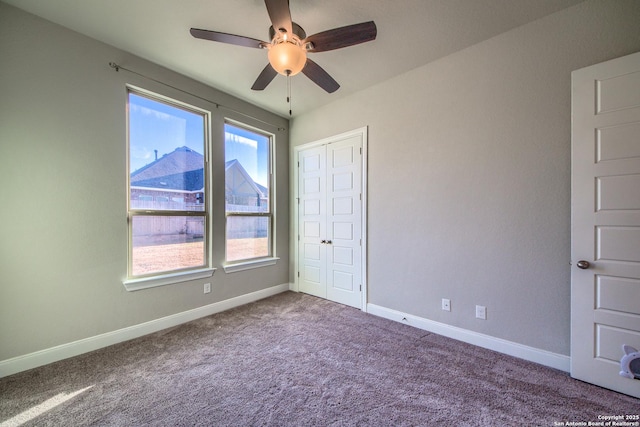 unfurnished bedroom featuring a ceiling fan, a closet, baseboards, and carpet flooring