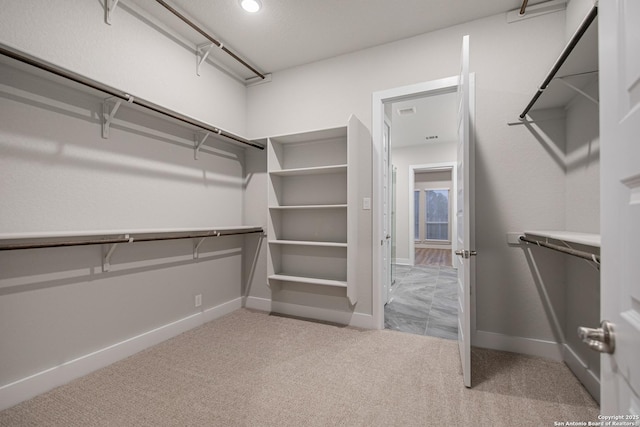 walk in closet with carpet floors