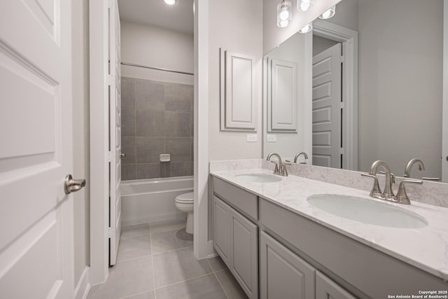 full bathroom featuring tile patterned flooring, a sink, toilet, and double vanity