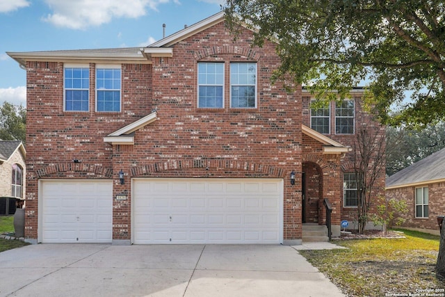 traditional-style home with a garage, concrete driveway, and brick siding