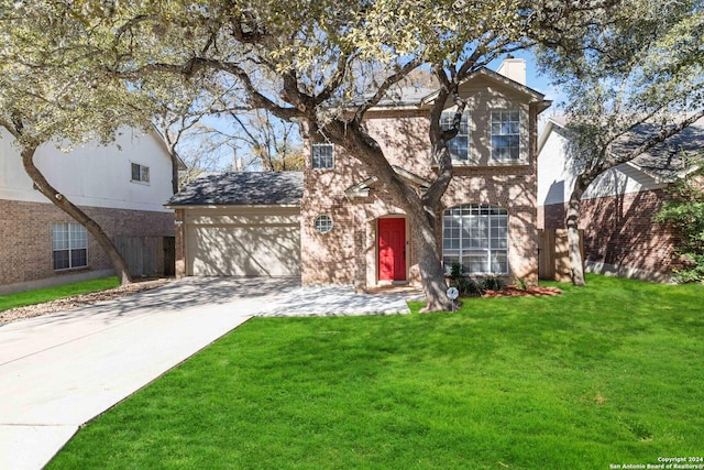 traditional home with driveway, a chimney, an attached garage, a front yard, and brick siding