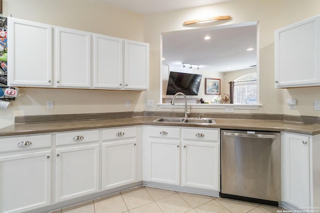 kitchen featuring a sink, white cabinets, dishwasher, and light tile patterned flooring