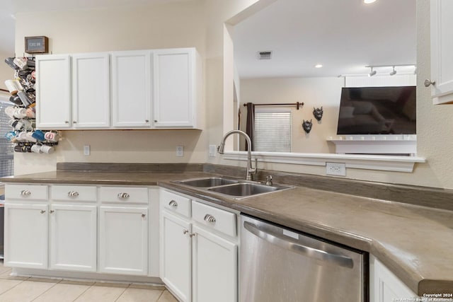 kitchen with light tile patterned floors, visible vents, white cabinets, dishwasher, and a sink