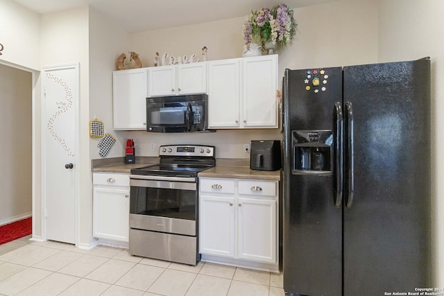 kitchen featuring baseboards, white cabinetry, black appliances, and light tile patterned flooring