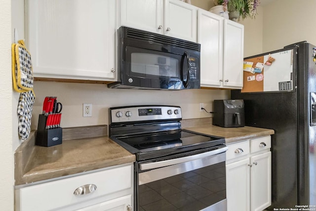 kitchen featuring black appliances, white cabinetry, and light countertops