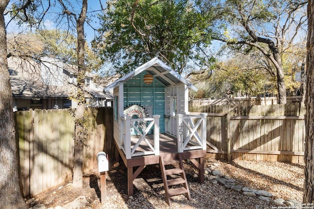 view of outbuilding featuring an outdoor structure and fence