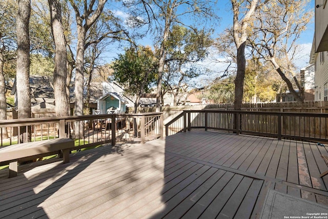 wooden terrace featuring fence