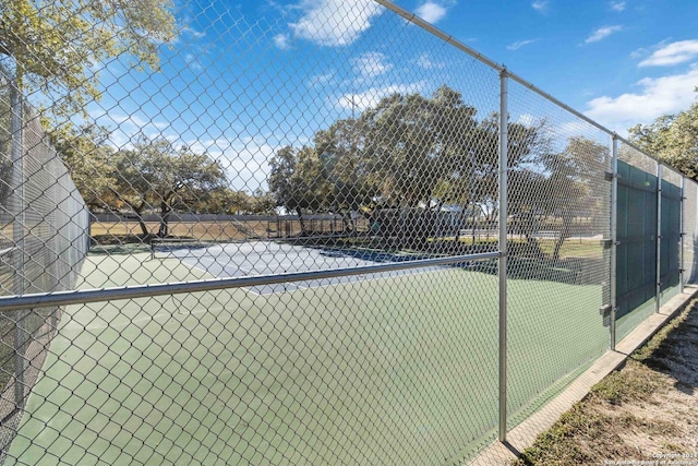 view of tennis court with fence