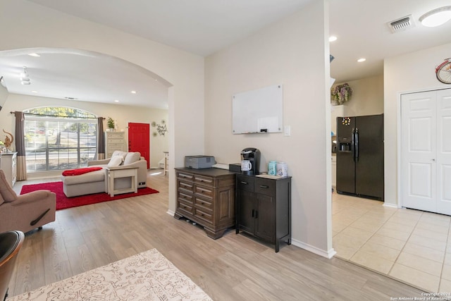 interior space featuring arched walkways, recessed lighting, visible vents, baseboards, and light wood-type flooring