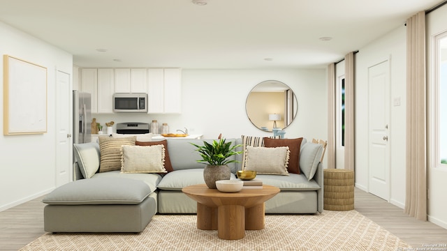 sitting room featuring light wood-style floors and baseboards