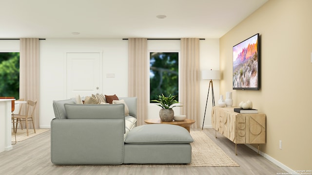 living area with light wood-type flooring and baseboards