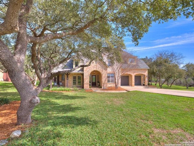 view of front of house with a front yard, driveway, and an attached garage