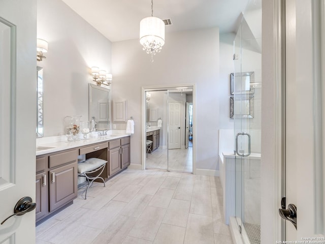 bathroom featuring double vanity, a stall shower, baseboards, visible vents, and a sink