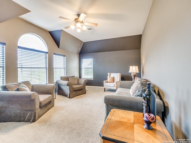 carpeted living area featuring lofted ceiling, ceiling fan, visible vents, and baseboards