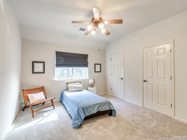 carpeted bedroom with vaulted ceiling, a ceiling fan, visible vents, and baseboards