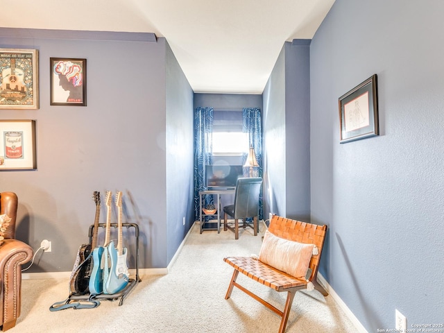 living area featuring carpet flooring and baseboards