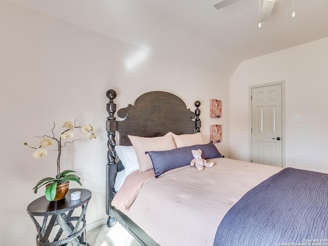 bedroom with vaulted ceiling, carpet floors, and a ceiling fan