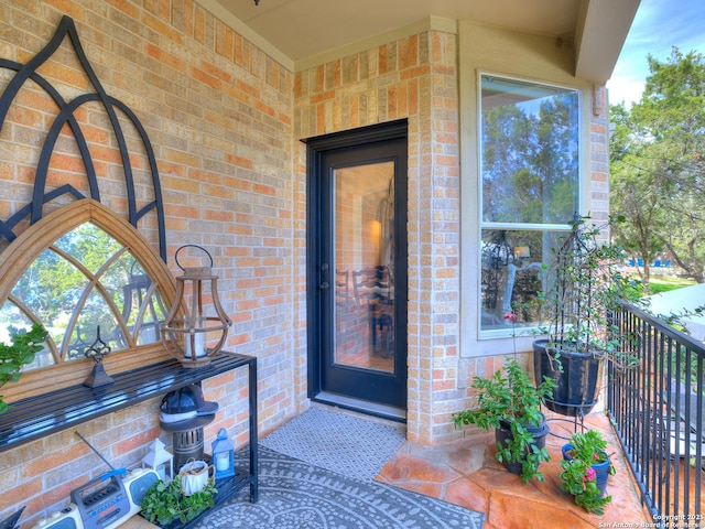 entrance to property featuring brick siding