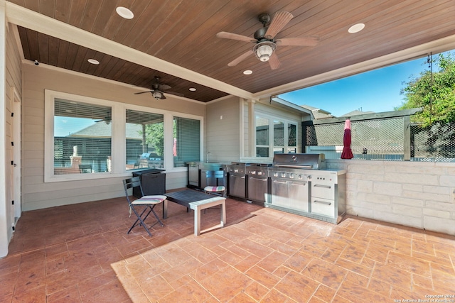 view of patio / terrace with a ceiling fan, a sink, fence, and area for grilling