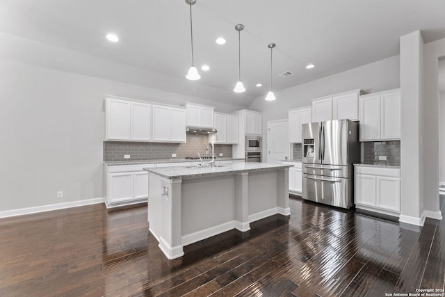 kitchen featuring dark wood-style flooring, appliances with stainless steel finishes, white cabinetry, an island with sink, and under cabinet range hood