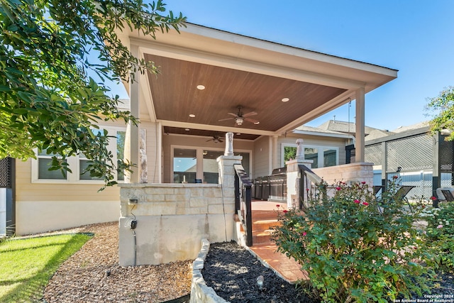 view of patio / terrace with ceiling fan and fence