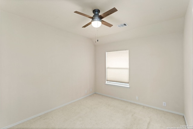 spare room with baseboards, ceiling fan, visible vents, and light colored carpet