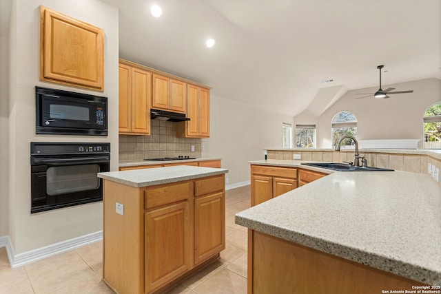 kitchen with a center island, light tile patterned floors, backsplash, under cabinet range hood, and black appliances