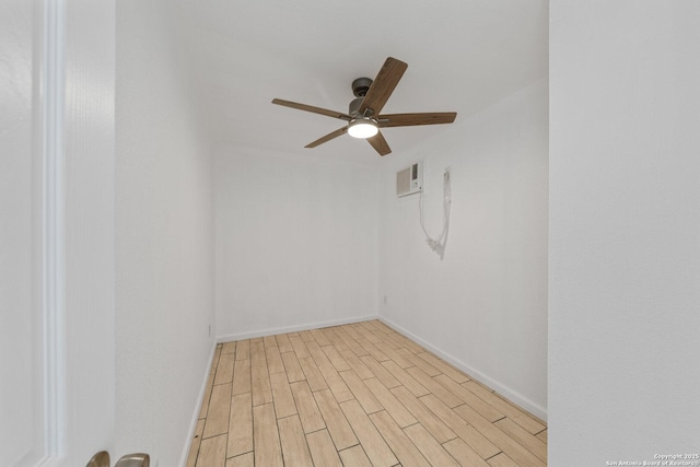 empty room with visible vents, light wood-type flooring, a ceiling fan, and baseboards