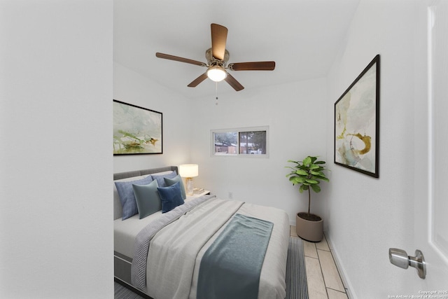 bedroom with a ceiling fan and baseboards