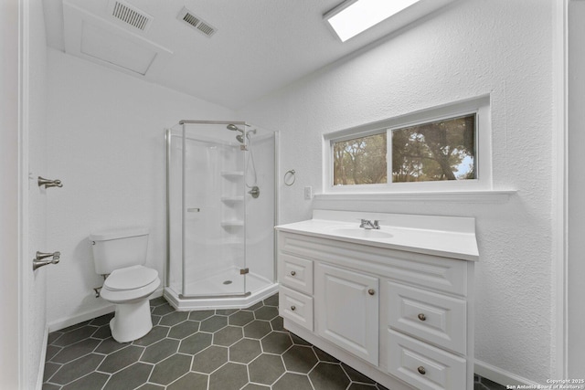 bathroom featuring a stall shower, visible vents, and toilet