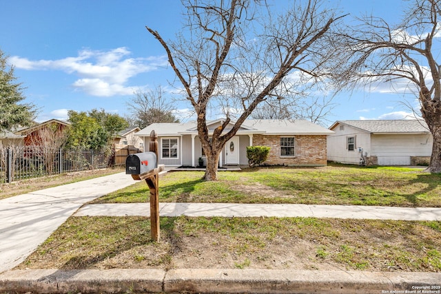 view of front of house with fence, a front lawn, concrete driveway, and brick siding