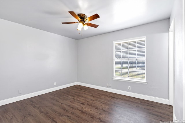 empty room featuring dark wood-style floors, ceiling fan, and baseboards