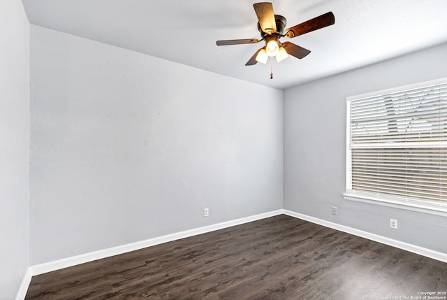 unfurnished room with a ceiling fan, dark wood finished floors, and baseboards